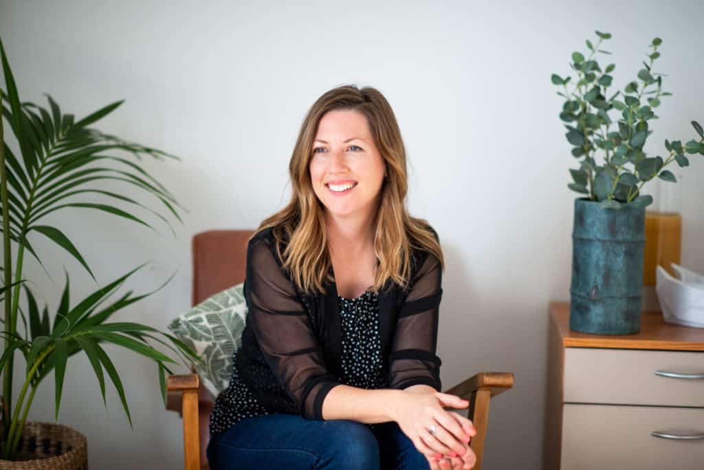 branding photo for auckland graphic designer sitting in chair in her home